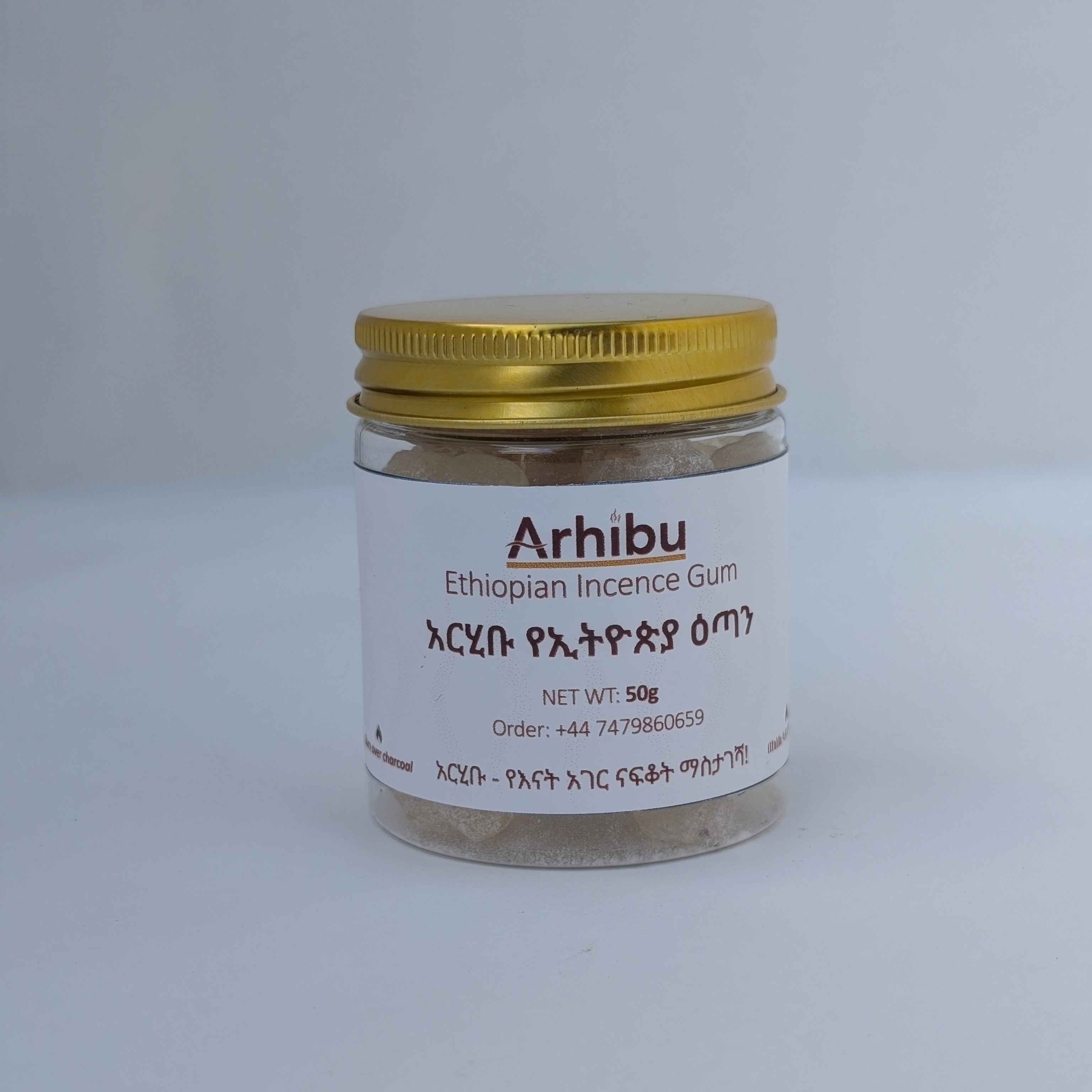 A small clear glass jar of Arhibu Ethiopian Incense Gum with a white label and a gold metal lid, set against a plain light gray background.