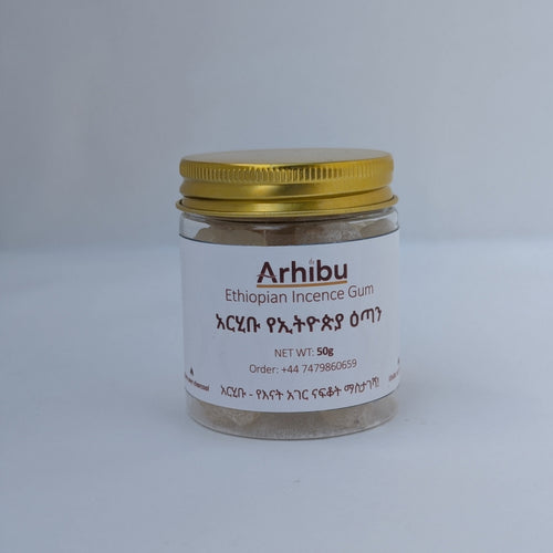 A small clear glass jar of Arhibu Ethiopian Incense Gum with a white label and a gold metal lid, set against a plain light gray background.